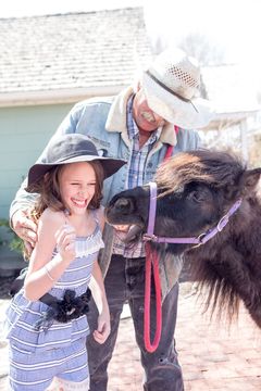 Little Buckaroo Petting Zoo - Petting a pony at Gardner Village 