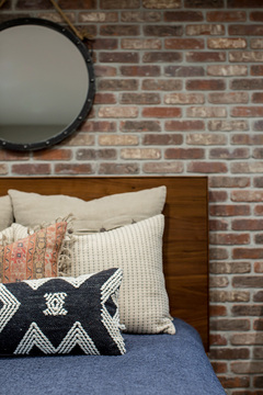 Down to Earth Projects | Castlefield Lane - Layered pillows bedroom interior design 