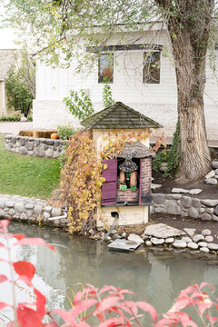 Gardner Village Witch Displays - witch looking into the pond 