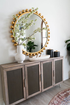 Down to Earth Projects | Kaysville Residence - console with large gold mirror and vases 