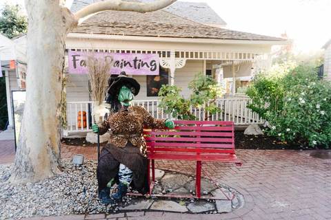Gardner Village Witch Displays - witch display sitting on a bench 