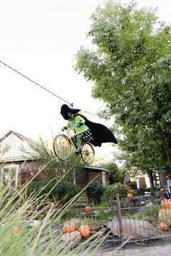 Gardner Village Witch Displays - witch pedaling a bike 