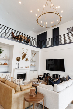 Down to Earth Projects | Eden Residence - family room with sofas, two chairs and white walls 