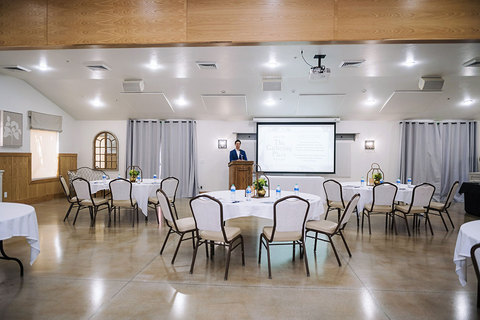 The Gathering Place Corporate Events - company event with tables and a presenter 