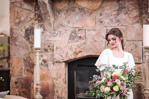 Weddings at The Gathering Place - bride by a fireplace 