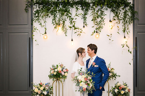 Weddings at The Gathering Place - bride and groom under flowers 