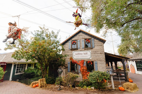 Gardner Village Witch Displays - witches flying on brooms along the main path 