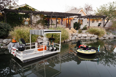 Gardner Village Witch Displays - witch on party barge with tube pulling behind 