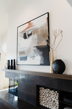 Down to Earth Projects | Salt Lake Residence - Fireplace decor with painting on wall above 