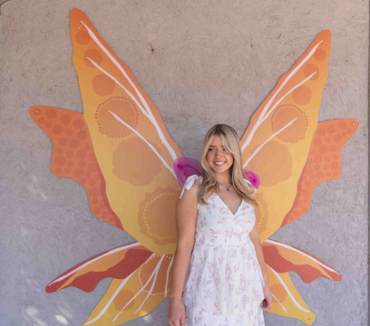 Woodland Fairy Festival - girl standing in front of fairy wings for photo op 