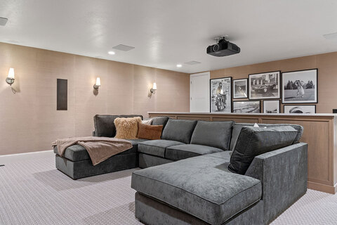 Down to Earth Projects<br>Symphony Homes Parade Ninth + North Design - in-home movie room with gray sectional 