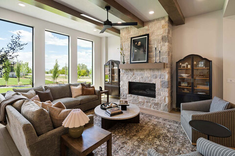 Down to Earth Projects<br>Symphony Homes Parade Ninth + North Design - family room with large fireplace and sectional 