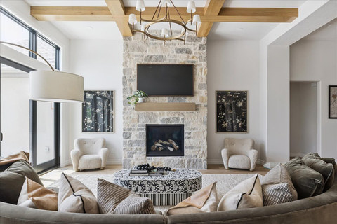 Down to Earth Projects<br>Symphony Homes Parade Ninth + North Design - curved sofa in large family room with coffee table 