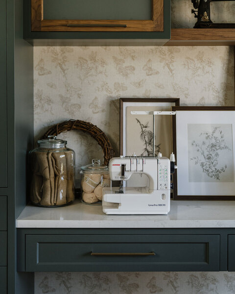 Down to Earth Projects | Utah Valley Parade at The Legacy at Meadow Ridge - Down to Earth Projects | Utah Valley Parade at The Legacy at Meadow Ridge - sewing machine on counter with green cabinets