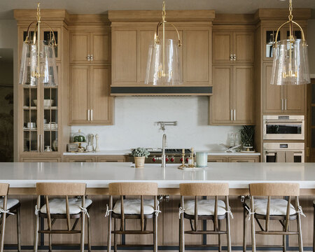 Down to Earth Projects | Utah Valley Parade at The Legacy at Meadow Ridge - kitchen with barstools around island and pendant lights 