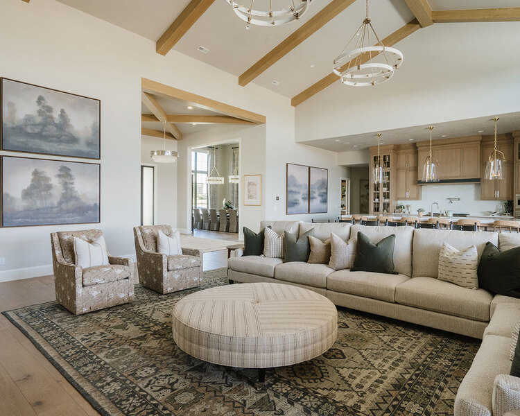 Down to Earth Projects | Utah Valley Parade at The Legacy at Meadow Ridge - Down to Earth Projects | Utah Valley Parade at The Legacy at Meadow Ridge - family room and kitchen great room with wood ceiling beams and furniture from down to earth