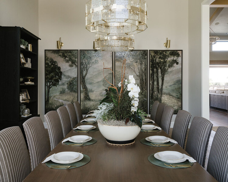 Down to Earth Projects | Utah Valley Parade at The Legacy at Meadow Ridge - Down to Earth Projects | Utah Valley Parade at The Legacy at Meadow Ridge - dining room with wall art and large table and fabric chairs