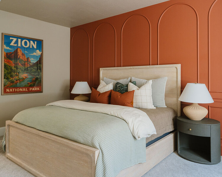 Down to Earth Projects | Utah Valley Parade at The Legacy at Meadow Ridge - Down to Earth Projects | Utah Valley Parade at The Legacy at Meadow Ridge - guest room with orange wall and light bed with nightstand