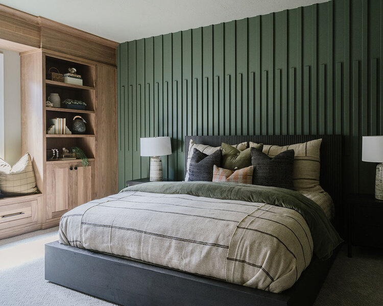 Down to Earth Projects | Utah Valley Parade at The Legacy at Meadow Ridge - Down to Earth Projects | Utah Valley Parade at The Legacy at Meadow Ridge - bedroom with green millwork wall and gray bed with bedding from Layers Bedding
