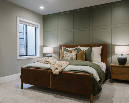 Down to Earth Projects | Utah Valley Parade at The Legacy at Meadow Ridge - bedroom with sage green wall and leather and wood bed 