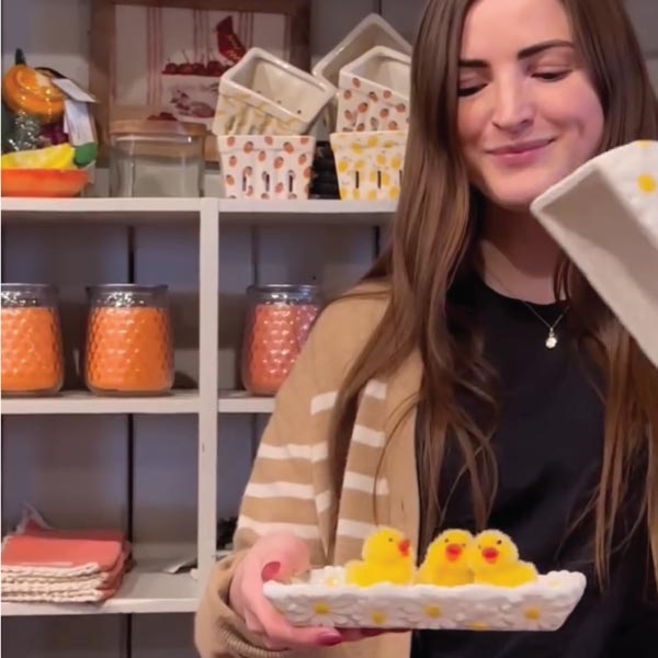 store manager with chicks on a butter dish