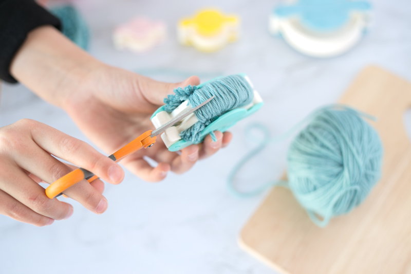creating diy yarn pom poms